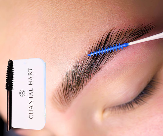 Eyebrow soap being used on an eyebrow with a spoolie