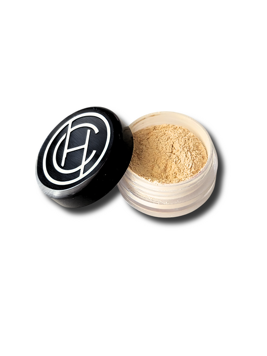 A small, open jar of Chantal Hart Warm Translucent Powder with the lid off, showing the mineral powder inside.