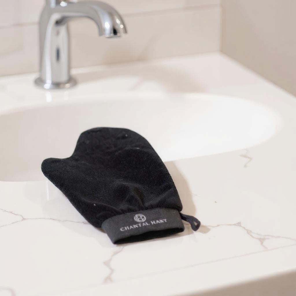 Black glove on a sink with 'Chantal Hart' branding