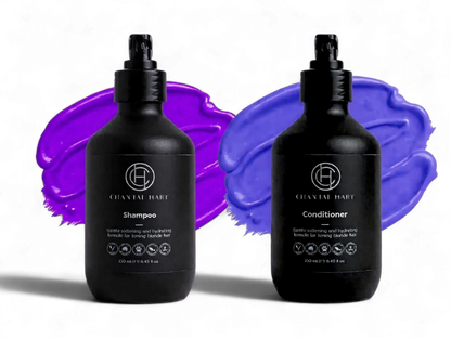 Two black bottles of Chantal Hart organic shampoo and conditioner with purple paint swatches on a white background