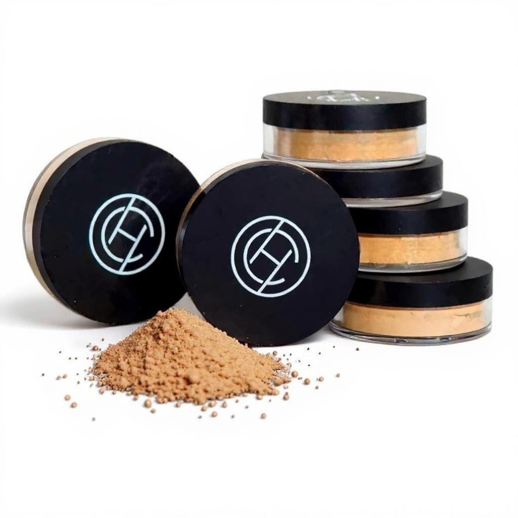 Cosmetic powders in black containers with a Chantal Hart logo on a white background