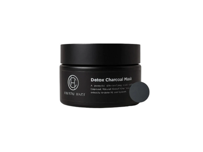 Black detox charcoal mask in jar with brand logo on a white background
