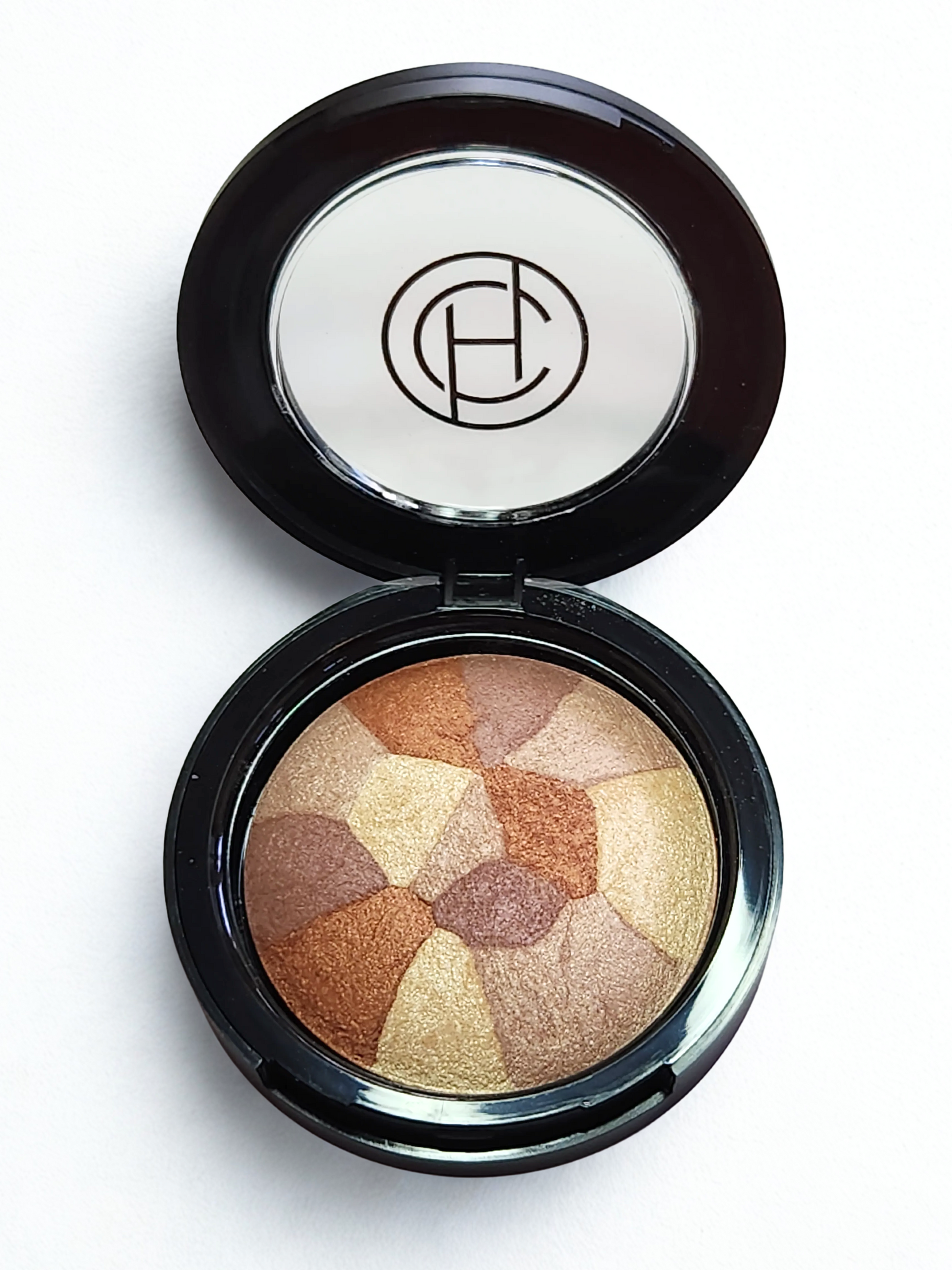 A multi tonal shimmer Bronzer makeup compact with a Chantal Hart brand logo on a white background