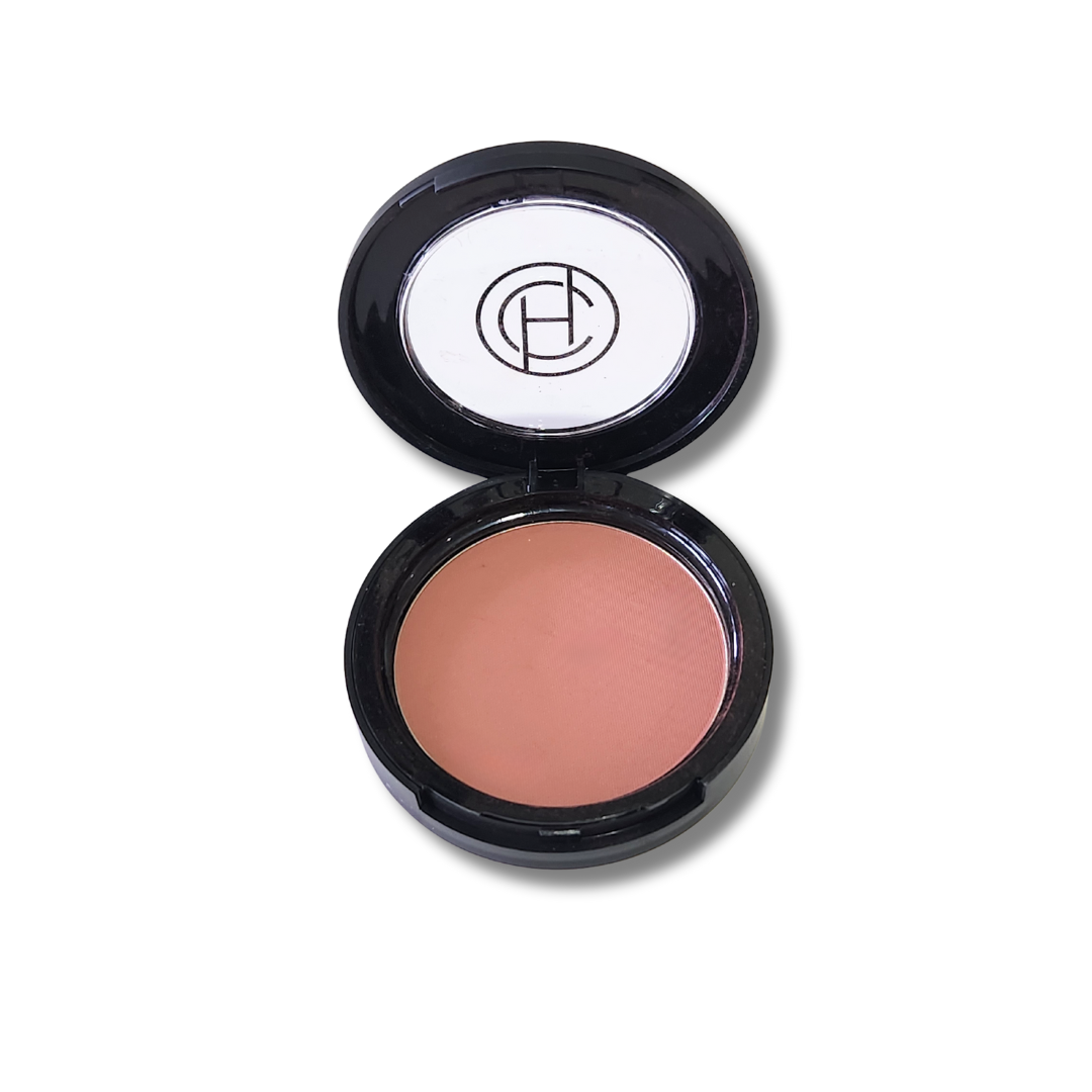 A compact mineral bronzer by Chantal Hart, open with the product visible inside the compact case.