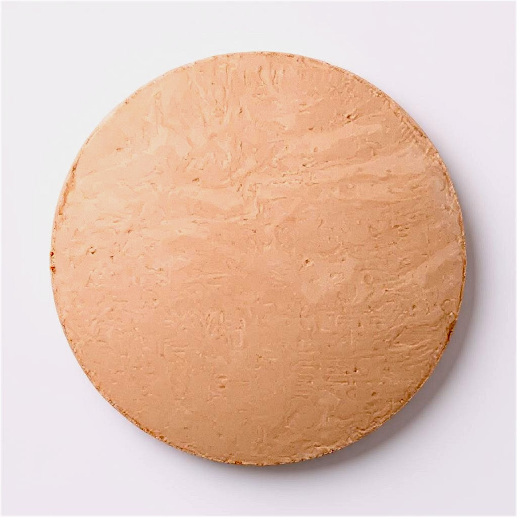 Round medium- beige foundation dome of makeup on a white background
