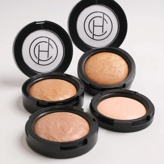 Set of makeup compacts with visible brand logo on a white background