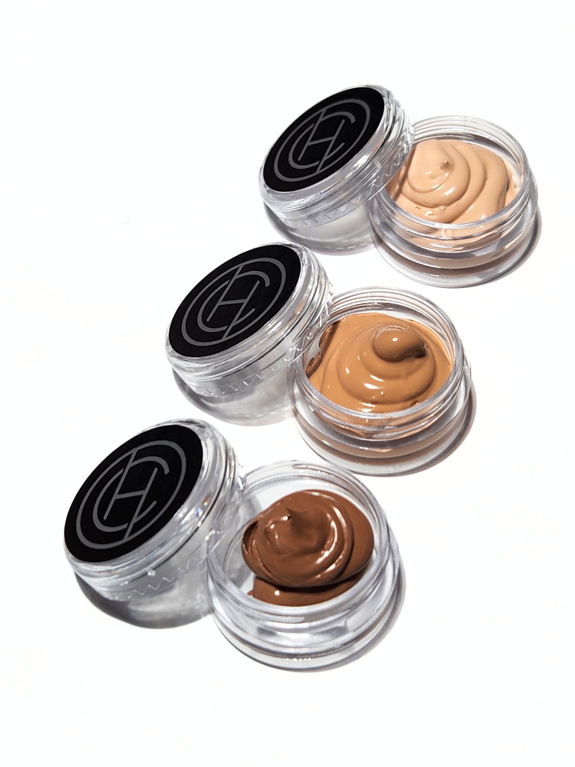 Three small, clear sample pots with different shades of Chantal Hart full coverage foundation.
