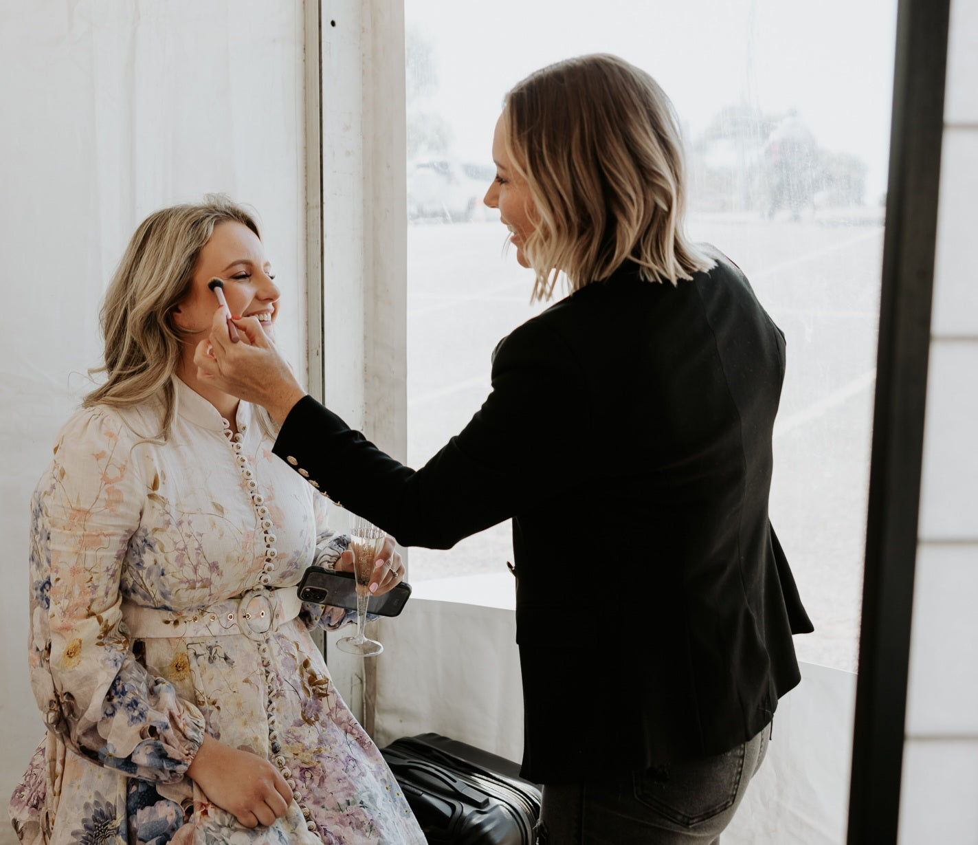 Chantal Hart applying makeup on a happy customer