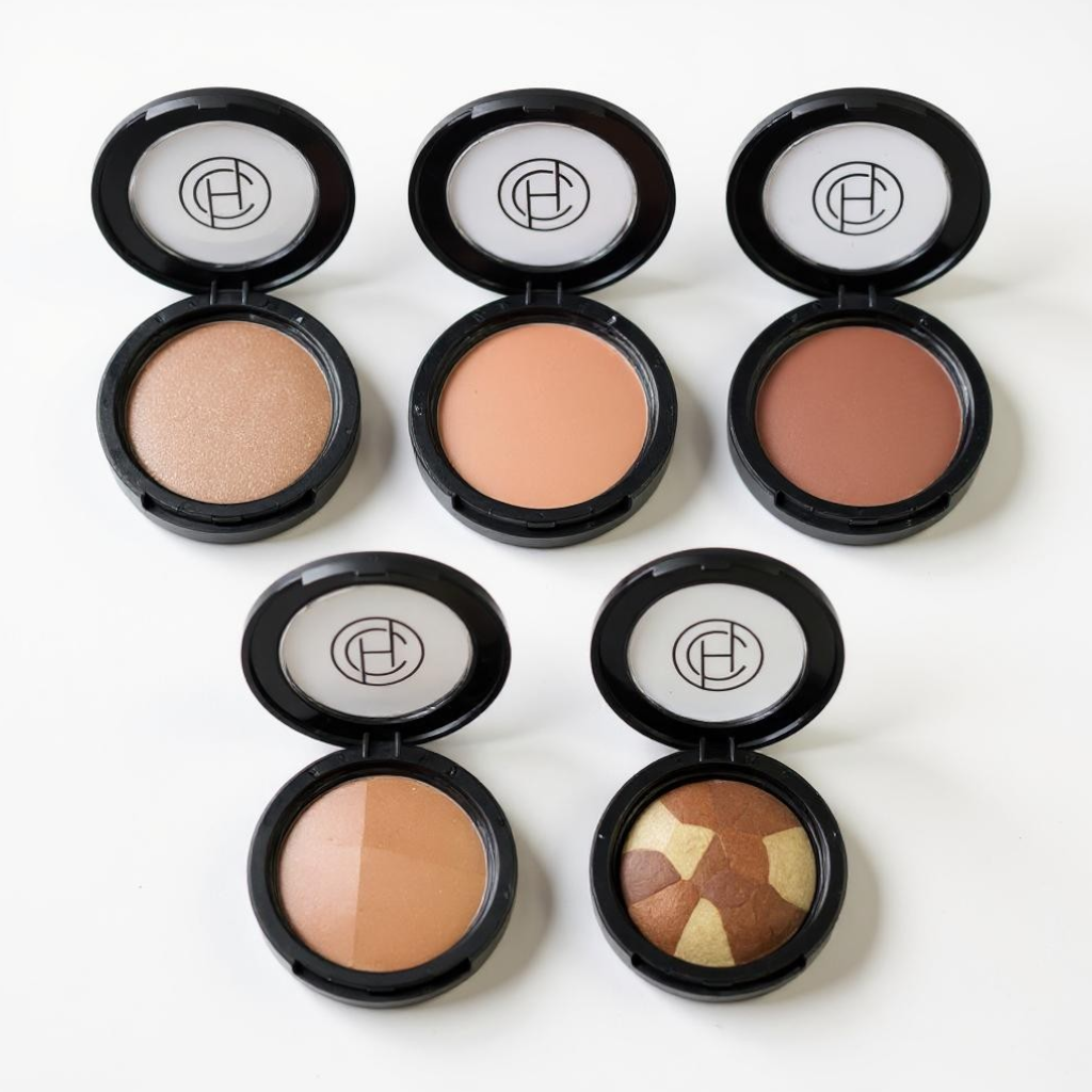 Five different types of mineral makeup bronzers in black compacts designed for warming and bronzing the skin