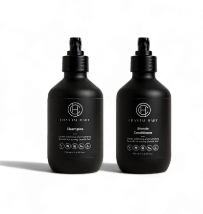Two black bottles of shampoo and conditioner on a white background