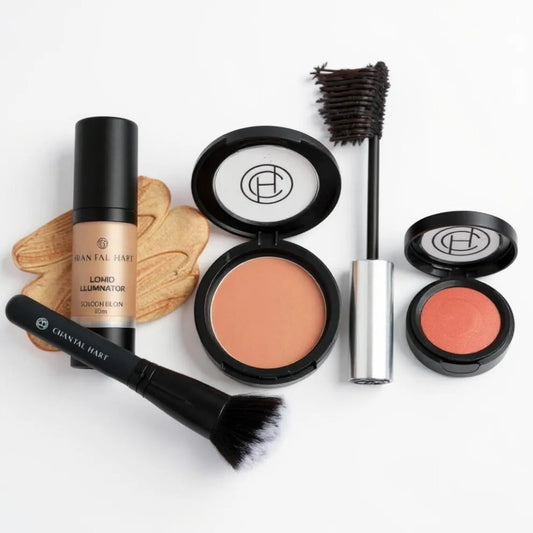 Makeup products including a brush, liquid illuminator, bronzing powder, mascara, and blush on a white background