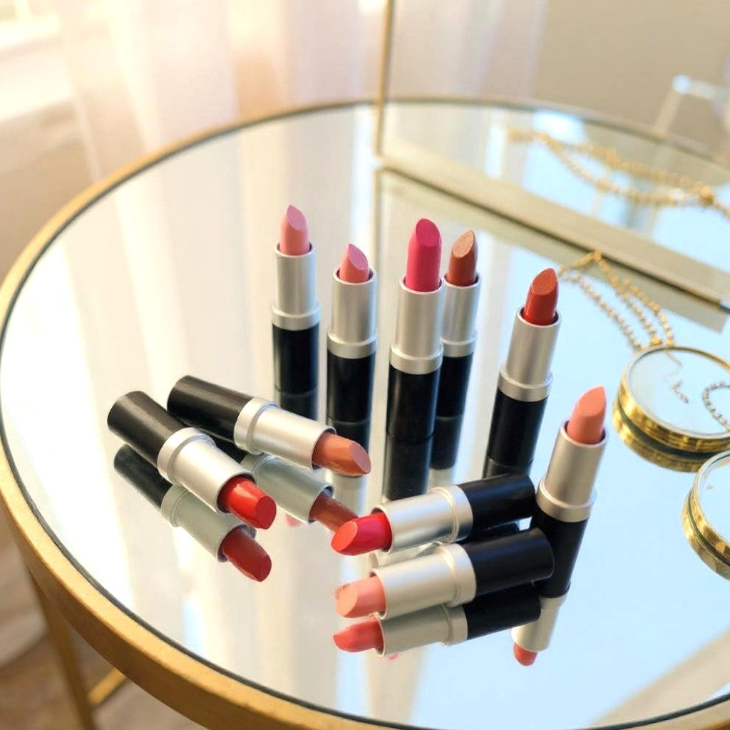 Collection of Chantal Hart lipsticks on a round glass table with a blurred background